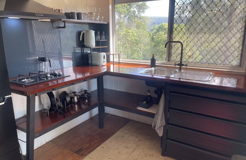 Wamuran Basin Cabin | Hayden's Place is a cozy tiny off‑grid home offering stunning 180° views.