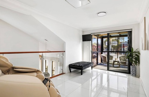 Rhodes House | Modern Rhodes Family Home with BBQ, Balcony & Two Living Areas