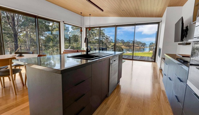 A modern and exquisitely decorated studio perched atop the serene shoreline in Forge Creek